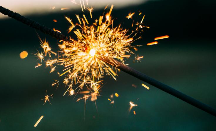 Two sparklers, one lighting the other. Keywords: Investments, UC Invest, ASIC, AFSL